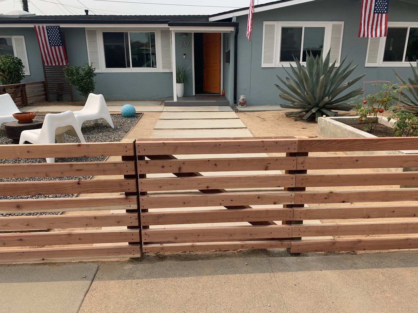 Modern horizontal-slat redwood fence and matching gate